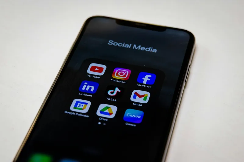 Smartphone displaying a folder titled "Social Media" with various popular app icons on a dark background
