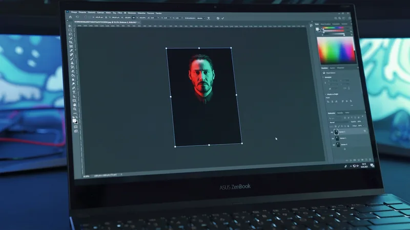 ASUS laptop screen showing photo editing software with a portrait of Keanu Reeves