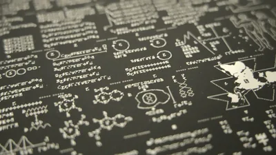 Close-up perspective of a dark print featuring Cosmic Call interstellar radio message symbols and diagrams