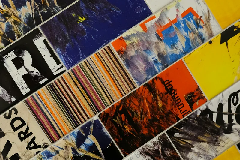 Colorful abstract collage of rectangular tiles featuring various art designs, textures, and typography